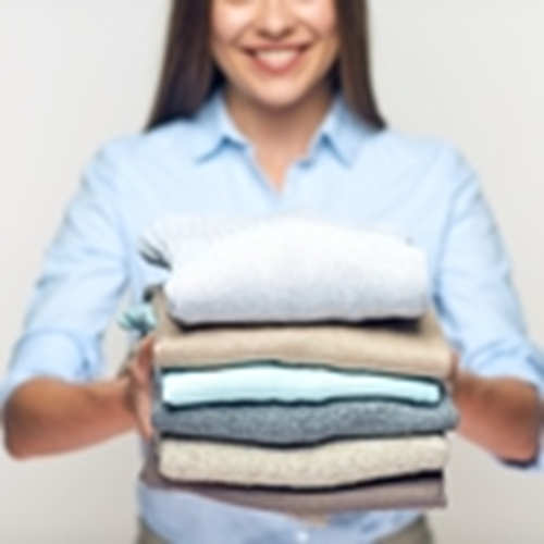 Woman Holding Stack Folded Clothes